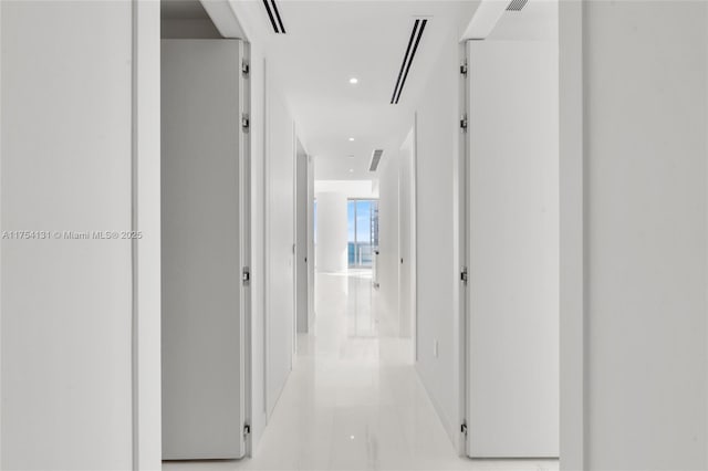 hallway featuring visible vents and recessed lighting