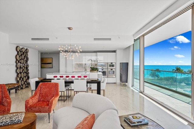 living room featuring a chandelier, marble finish floor, visible vents, and floor to ceiling windows