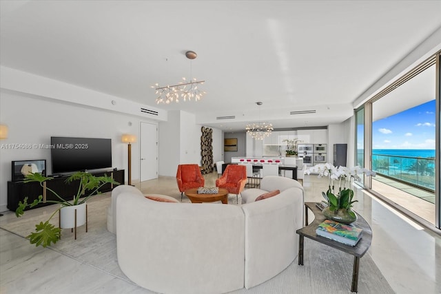 living room featuring a chandelier and concrete flooring