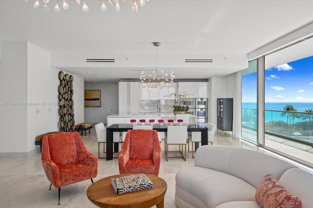 living room featuring an inviting chandelier and floor to ceiling windows