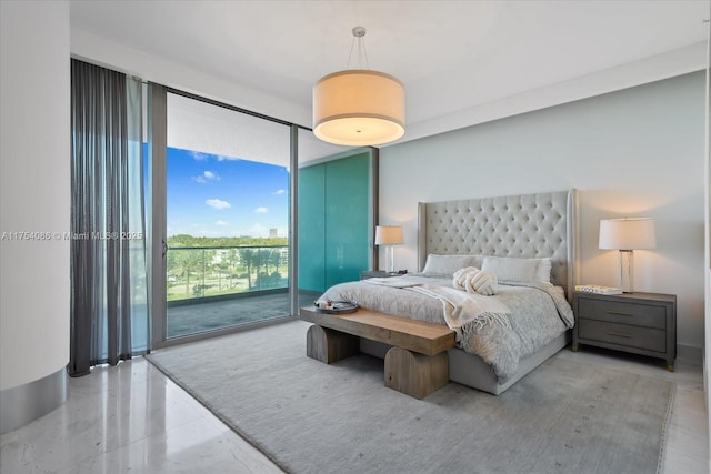 bedroom featuring expansive windows and access to exterior