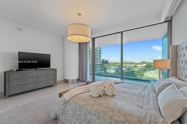 bedroom with access to outside and expansive windows