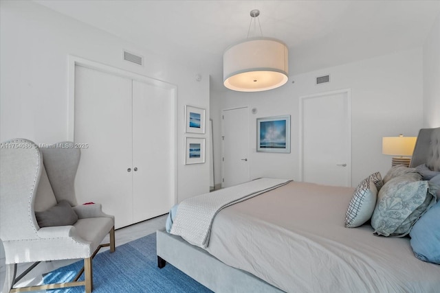 bedroom featuring a closet and visible vents