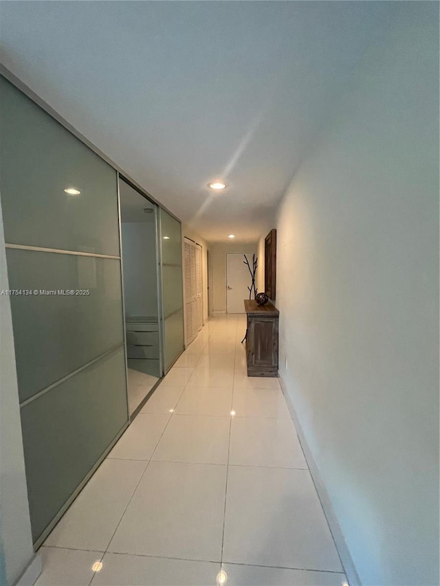 corridor featuring light tile patterned floors and recessed lighting