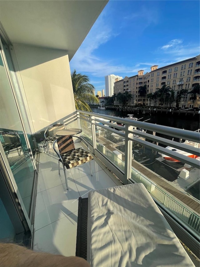 balcony with a water view and a city view