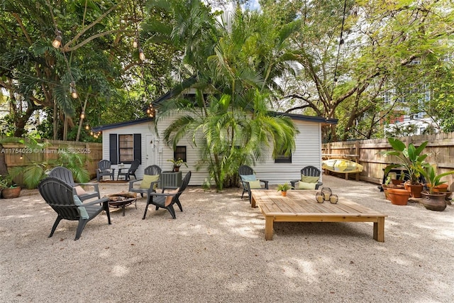 view of patio with an outdoor fire pit and fence