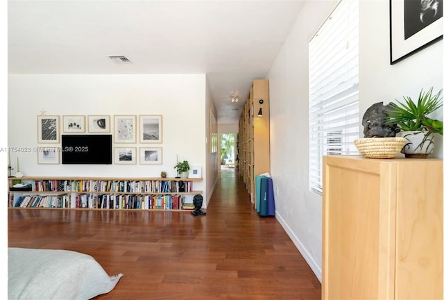 interior space featuring wood finished floors, visible vents, and baseboards