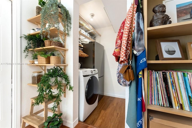 washroom with washer / dryer, laundry area, baseboards, and wood finished floors