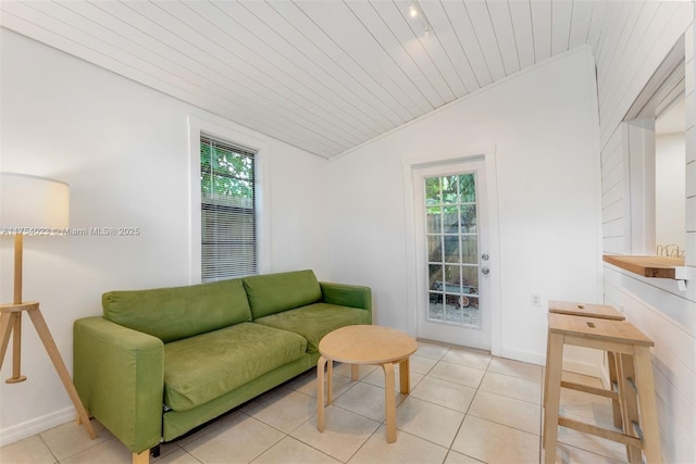 living room featuring a wealth of natural light, wood ceiling, light tile patterned flooring, and vaulted ceiling