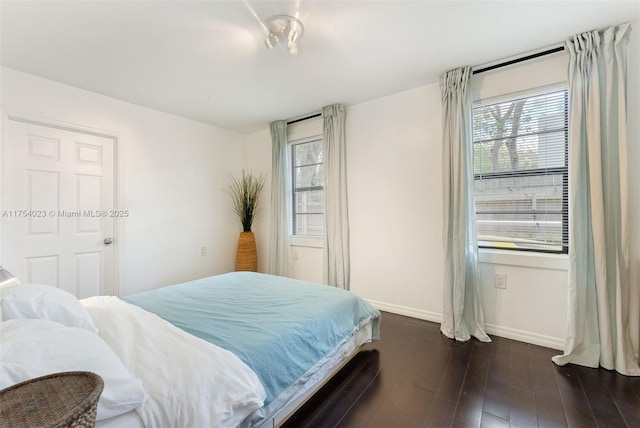 bedroom featuring dark wood-style flooring and baseboards