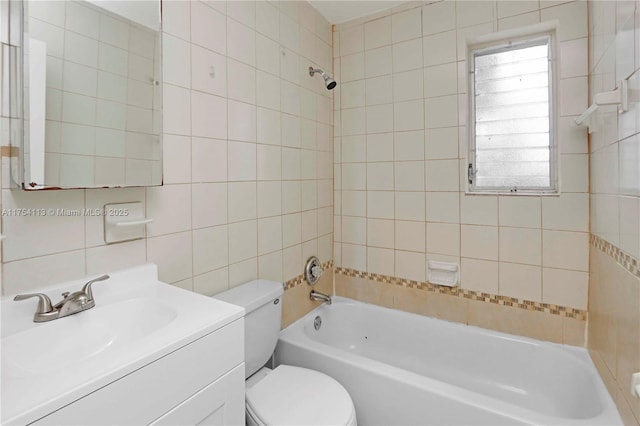 bathroom featuring toilet, vanity, tile walls, and shower / bathtub combination