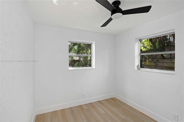 unfurnished room featuring light wood-style flooring and baseboards