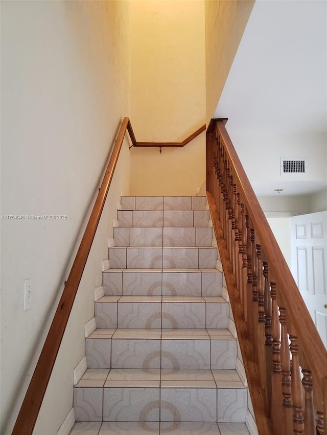 staircase featuring visible vents