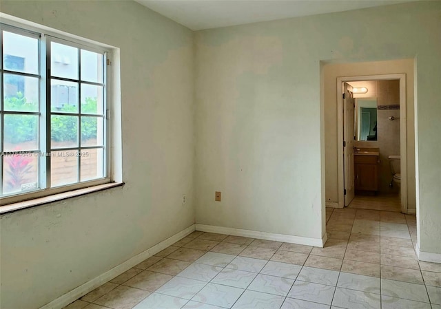 unfurnished room featuring baseboards