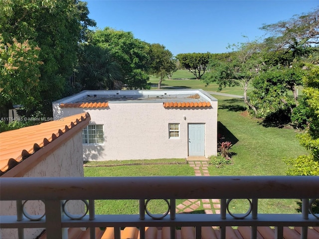 exterior space featuring a lawn and stucco siding