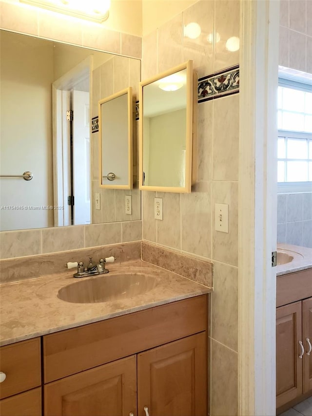 bathroom with tile walls and vanity