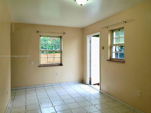 spare room with light floors and a healthy amount of sunlight