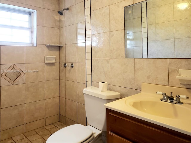 full bathroom with tile walls, toilet, vanity, and tiled shower