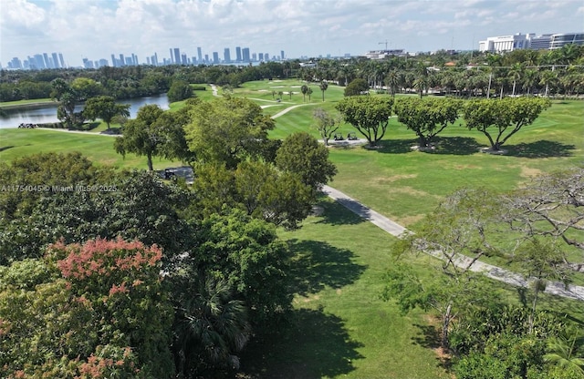aerial view featuring view of golf course, a water view, and a view of city