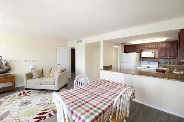 dining room featuring visible vents and wood finished floors