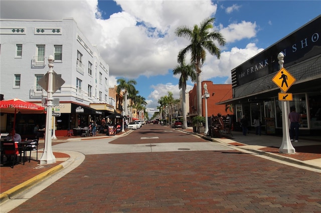 view of road featuring traffic signs, curbs, and sidewalks