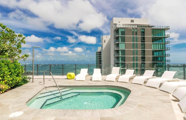 view of swimming pool featuring a community hot tub and a patio