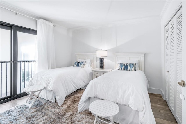 bedroom featuring crown molding, baseboards, access to outside, and wood finished floors