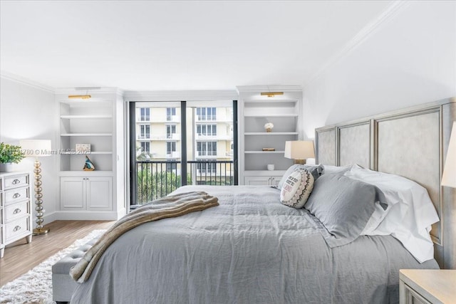 bedroom featuring access to outside, ornamental molding, and wood finished floors