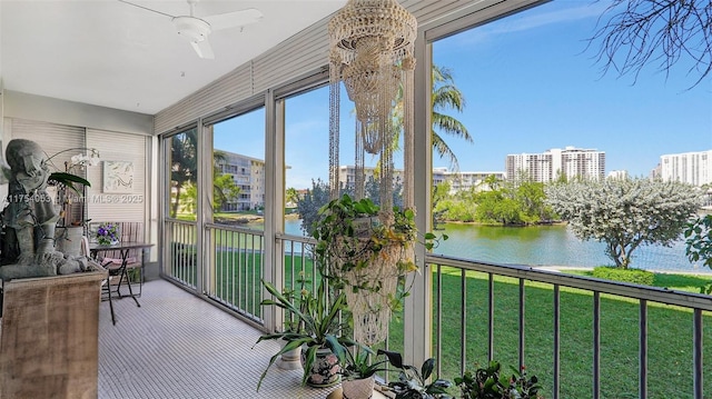 sunroom / solarium featuring a water view