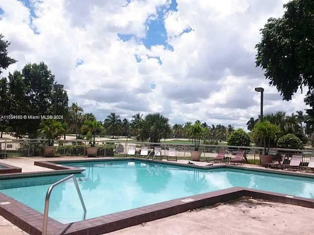 community pool featuring fence