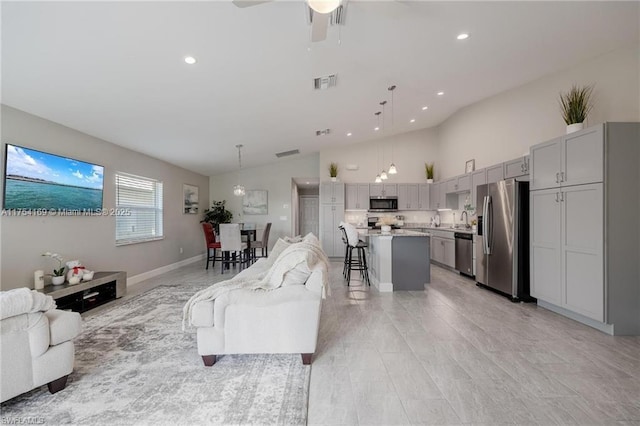 living room with baseboards, visible vents, a ceiling fan, high vaulted ceiling, and recessed lighting