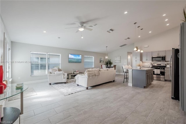 living room with high vaulted ceiling, ceiling fan, visible vents, and baseboards