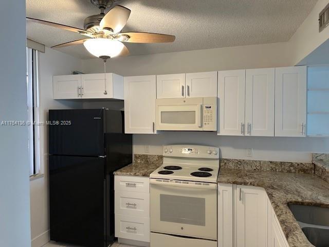 1524 Whitehall Dr Unit 102, Davie, FL 33324 - kitchen featuring white appliances, white cabinets, a ceiling fan, dark stone countertops, and a textured ceiling