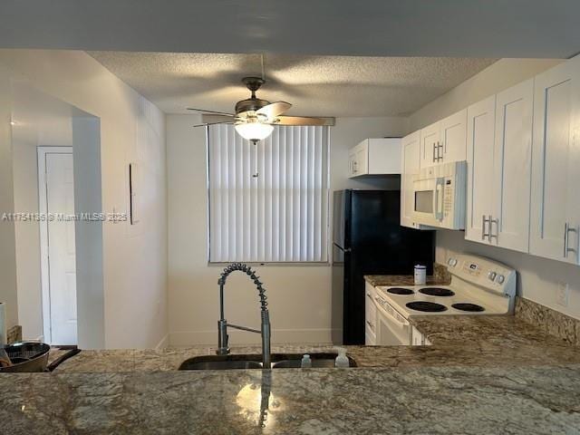 1524 Whitehall Dr Unit 102, Davie, FL 33324 - kitchen with white appliances, a textured ceiling, dark stone countertops, ceiling fan, and white cabinetry