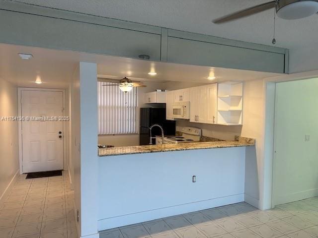 1524 Whitehall Dr Unit 102, Davie, FL 33324 - kitchen with white microwave, a ceiling fan, open shelves, stove, and freestanding refrigerator