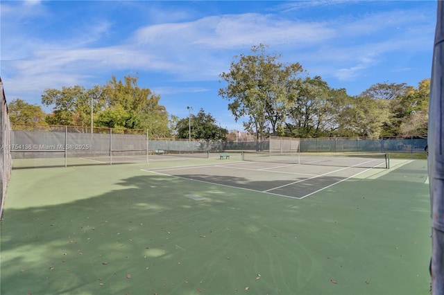 view of sport court with fence