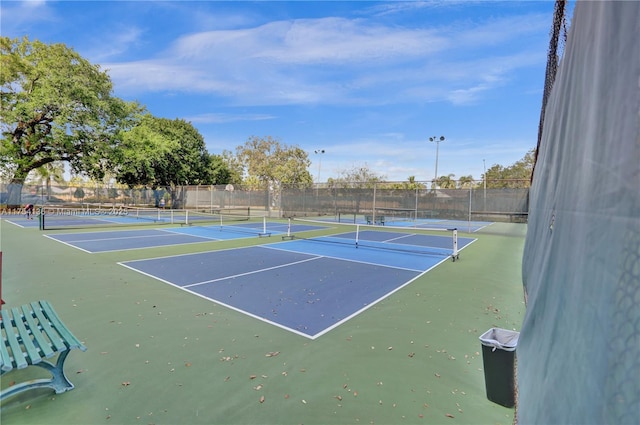 view of tennis court featuring fence