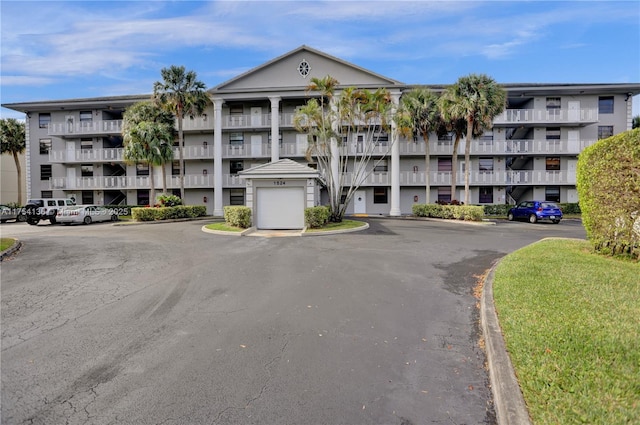 view of property featuring uncovered parking