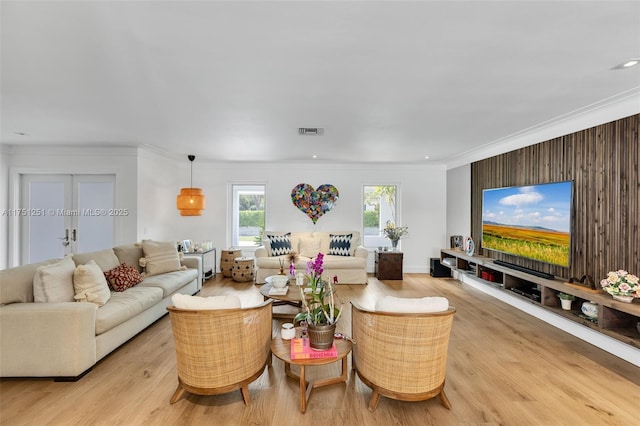 living room with baseboards, visible vents, crown molding, light wood-style floors, and recessed lighting