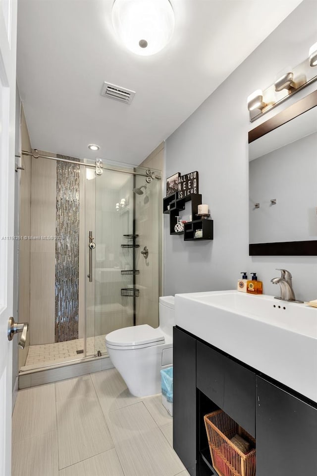 full bathroom with toilet, vanity, visible vents, a shower stall, and tile patterned floors