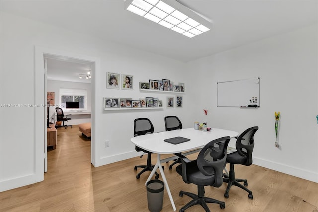 home office featuring light wood-style flooring and baseboards