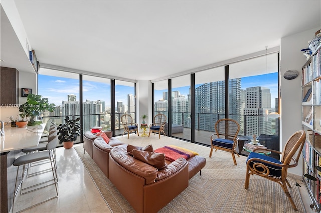 living area with expansive windows, plenty of natural light, a view of city, and tile patterned flooring