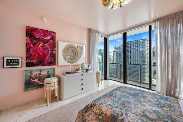 bedroom with a view of city, access to outside, floor to ceiling windows, and tile patterned floors