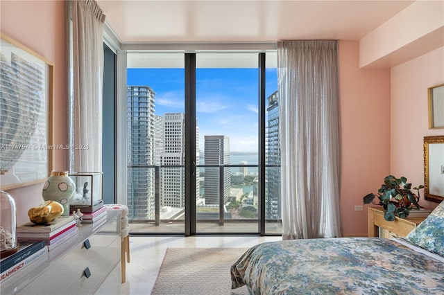 bedroom with access to exterior, a view of city, and floor to ceiling windows