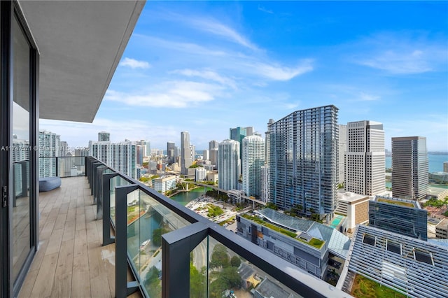 balcony featuring a city view and a water view