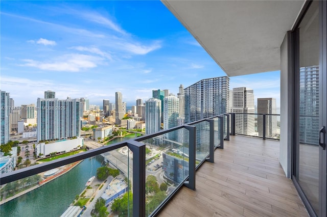 balcony featuring a water view and a view of city