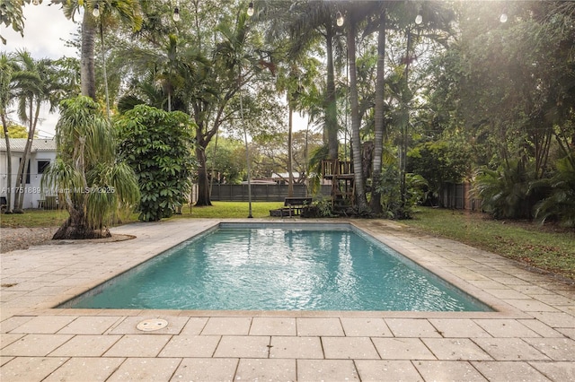 view of swimming pool featuring a patio area, a fenced in pool, and a fenced backyard