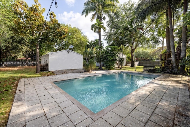 view of pool with fence, a yard, a patio area, and a fenced in pool