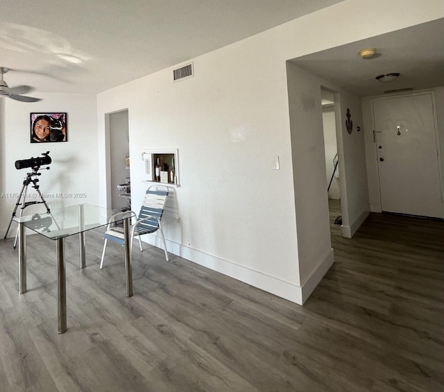 interior space with baseboards, visible vents, and wood finished floors