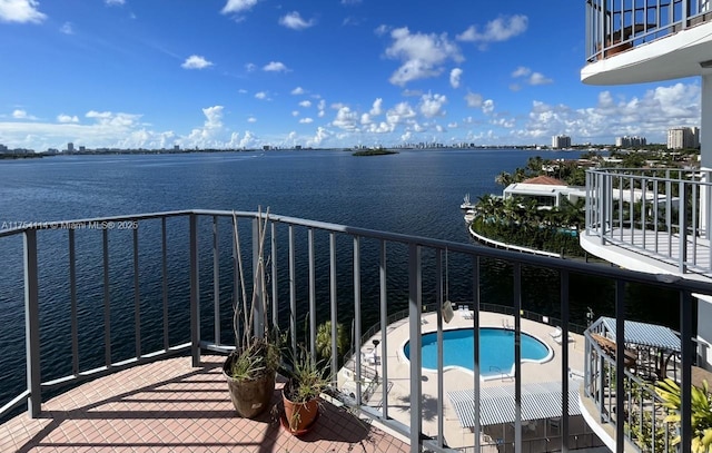 balcony featuring a water view and a jacuzzi